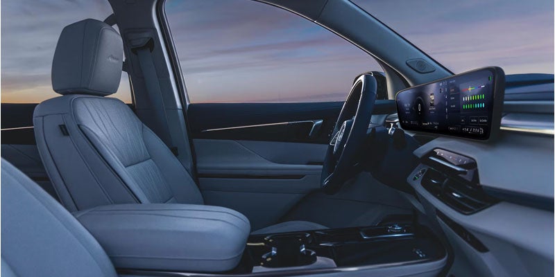 Buick Enclave front interior featuring leather seats, dashboard, and center console