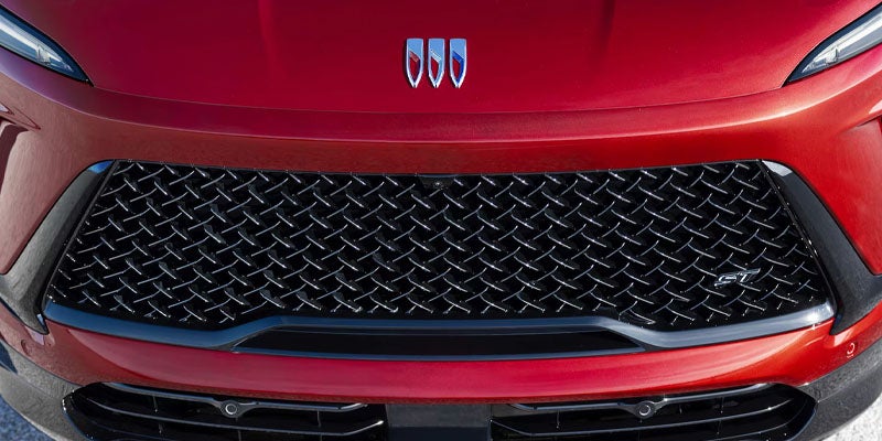 Buick front grille detail with tri-shield emblem and mesh pattern design
