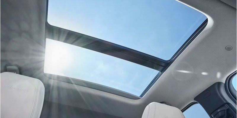 Panoramic sunroof inside a Buick SUV with bright natural sunlight