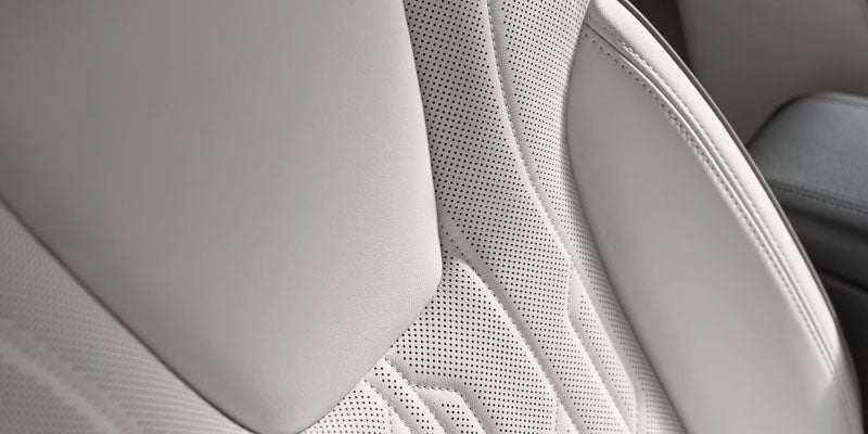 Perforated leather seat upholstery detail with premium stitching
