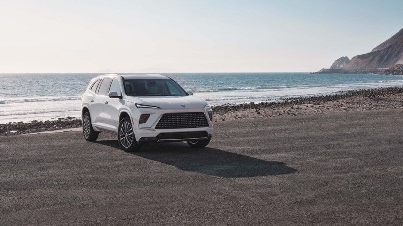 White Buick Enclave SUV on a coastal road
